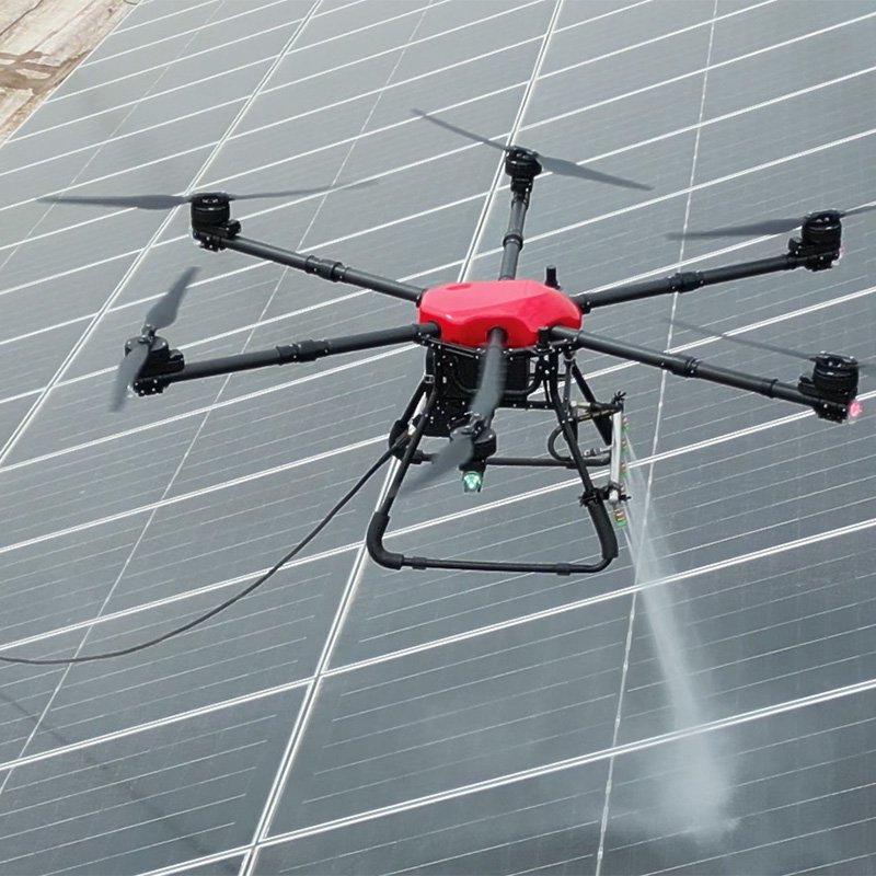 Solar panel cleaning drone performing high-pressure washing on photovoltaic panels