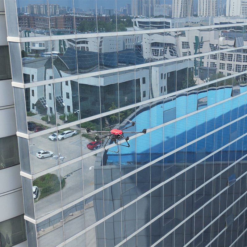 Professional window cleaning drone performing automated glass facade washing on a high-rise building